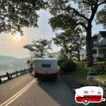 Vintage-Camper-Rounding-Old-Mansion-on-Lake-Waramaug